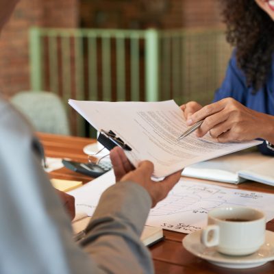 Businessman consulting with lawyer before signing contract